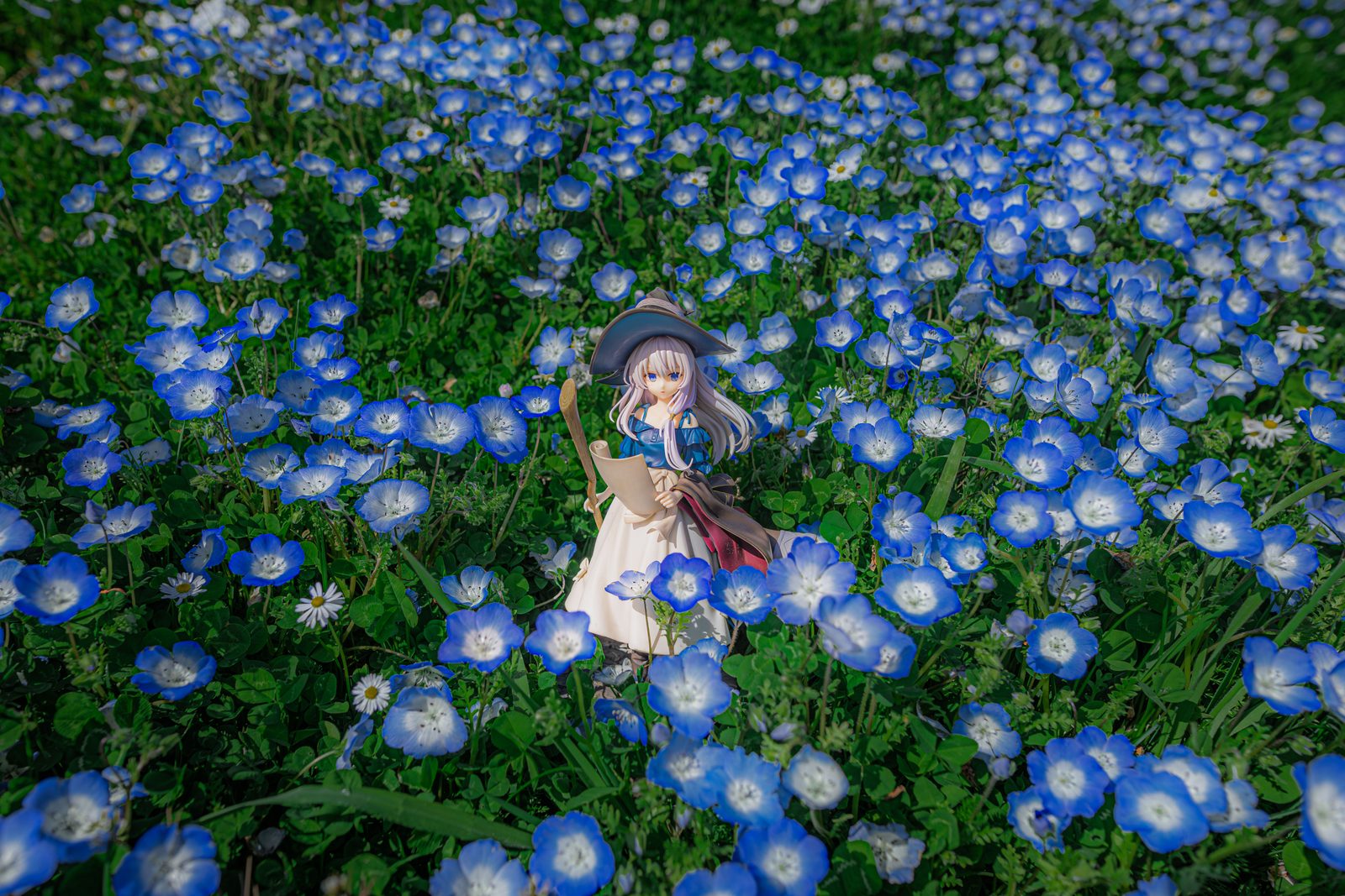 Figure in nemophila field